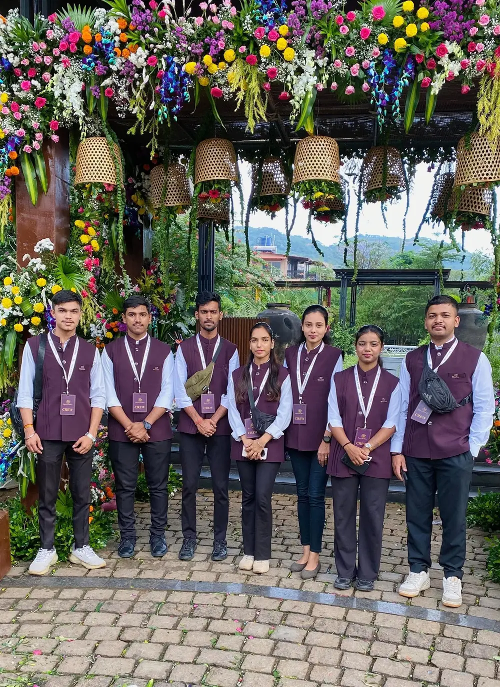 TNP team in waistcoats under a floral arch